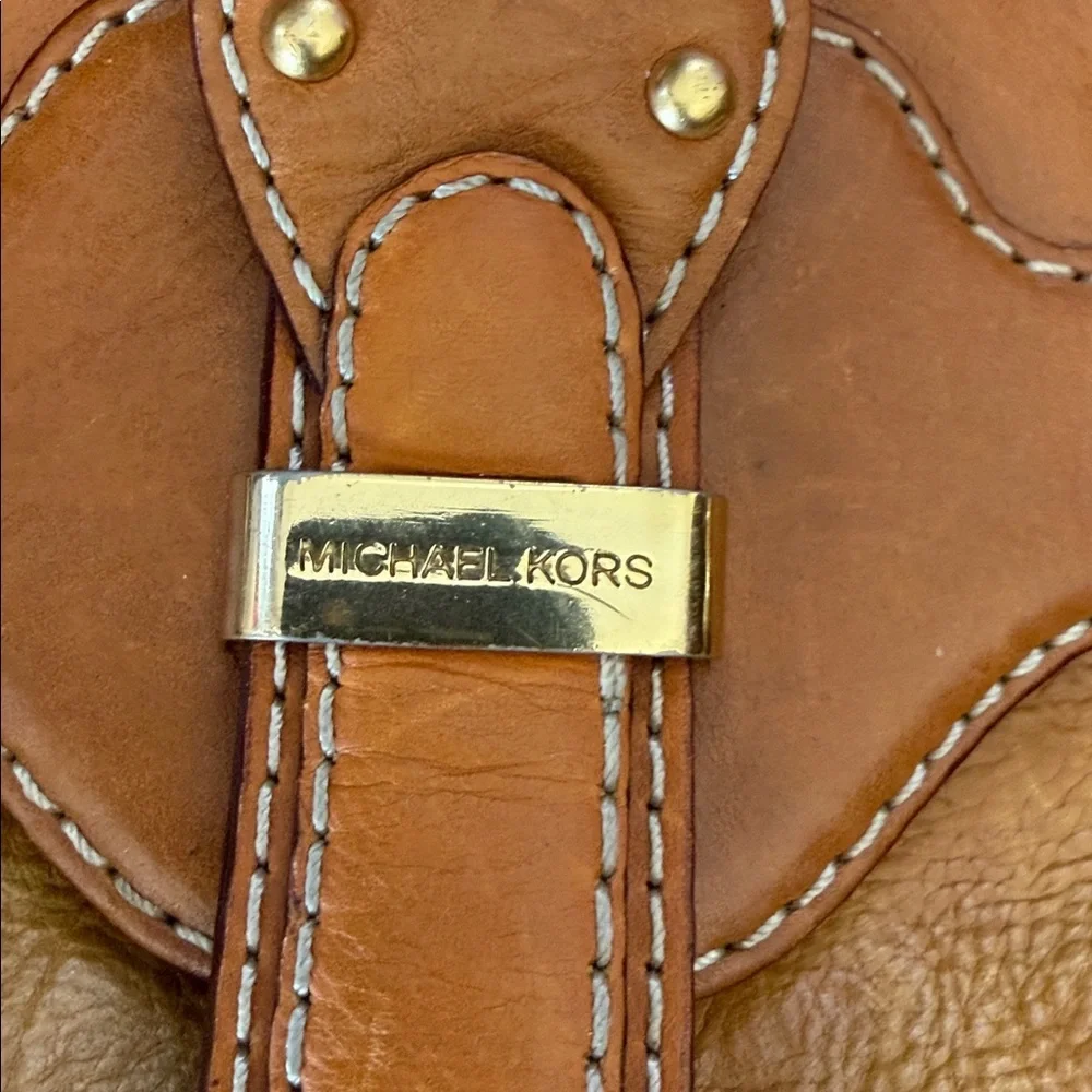 This is a vintage Michael Kors brown leather shoulder bag featuring gold studs